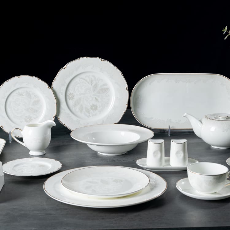 An elegant bone china dinnerware set featuring floral patterns and gold rims, designed for upscale dining in hotels and restaurants.