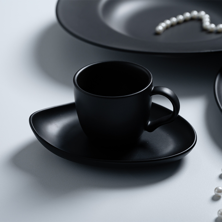 This image showcases a beautifully crafted black porcelain cup and saucer set, epitomizing elegance and sophistication.