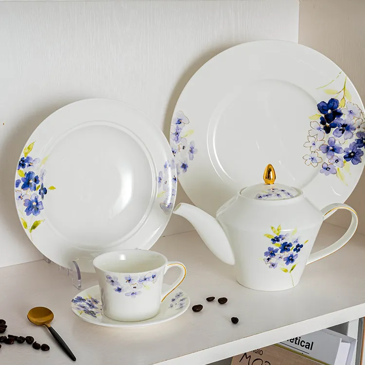 This image showcases a beautifully arranged tea set made from high-quality bone china, featuring a delicate blue floral design.
