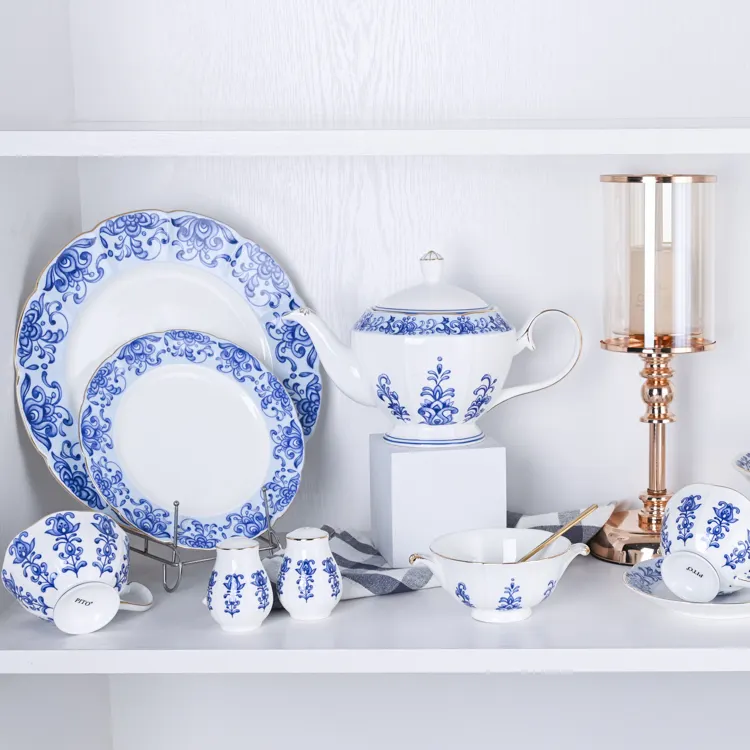 This image presents a refined collection of bone china tableware, including bowls, plates, and cups, all featuring elegant blue floral designs.