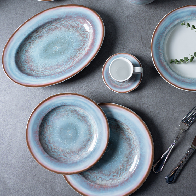 This image presents a top-down view of an exquisite porcelain dinnerware collection, characterized by its striking blue and brown marbled design.