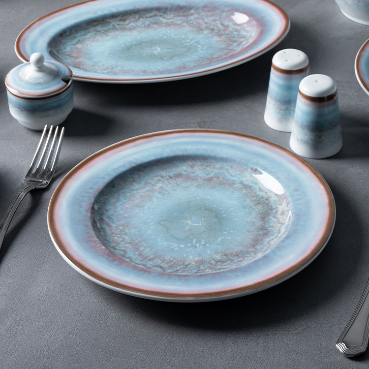 This image features a comprehensive porcelain dining set, including a teapot, a soup bowl with a saucer, an oval serving plate, a dinner plate.