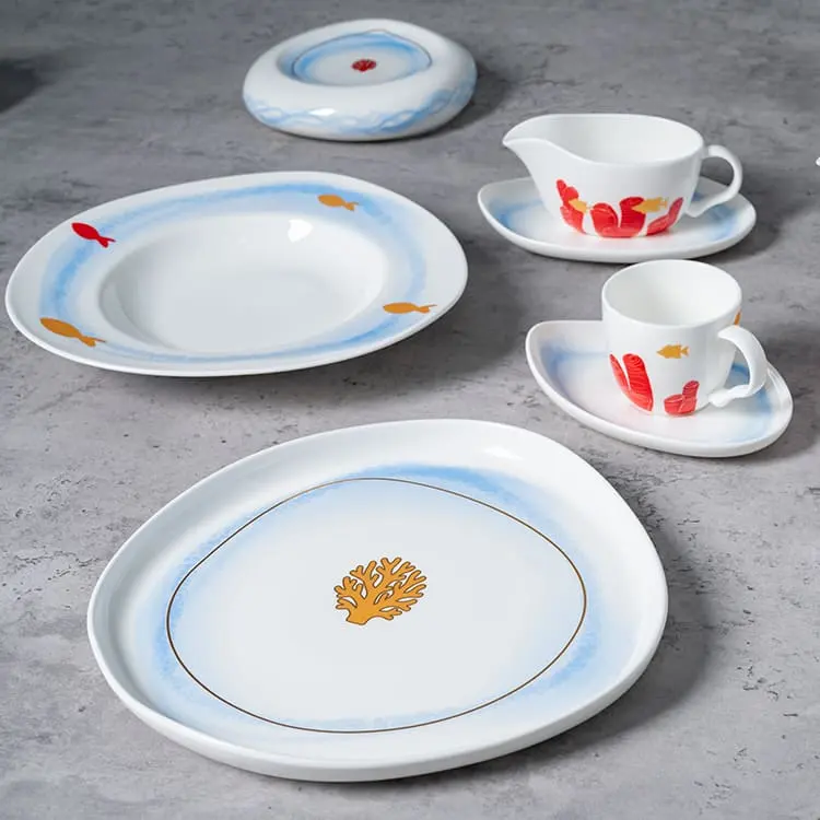 This image presents an assortment of the Coral Reef Dinnerware pieces, including a plate, cup, saucer, and gravy boat.