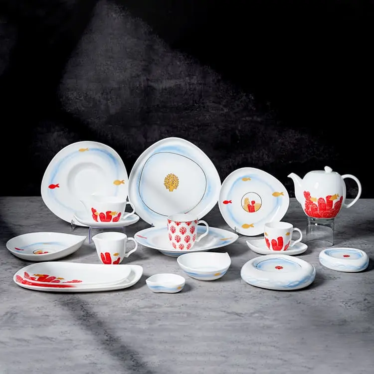 This image showcases the full collection of the Coral Reef Dinnerware set, displaying a wide range of pieces including plates, cups, saucers, and a teapot.