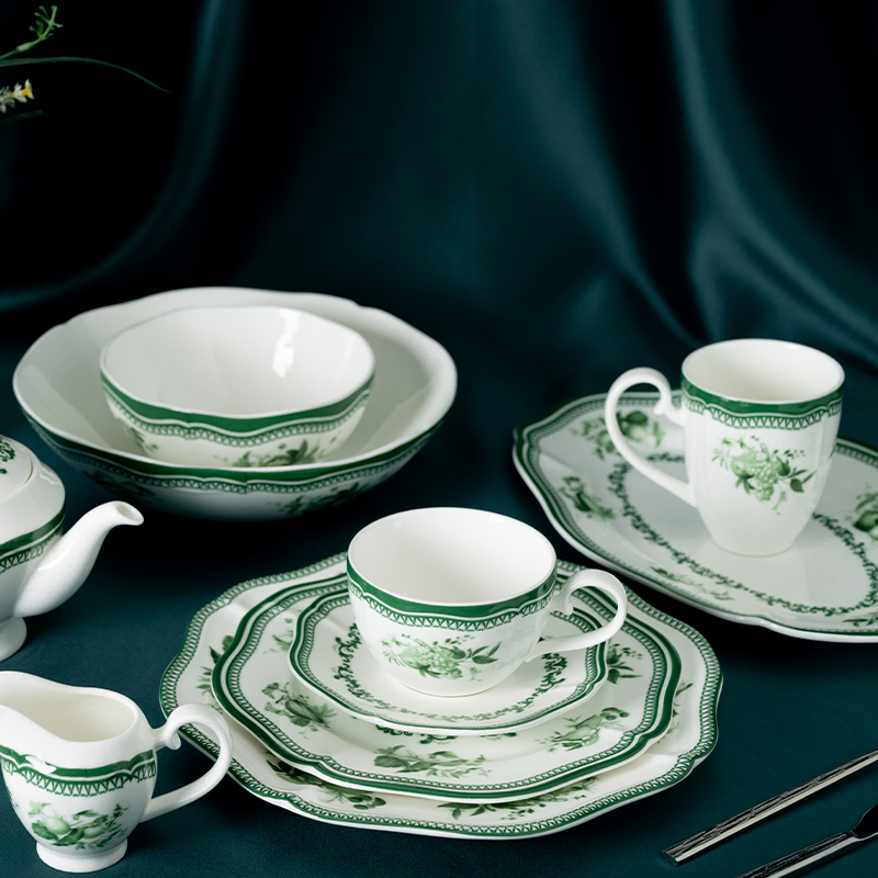 This image showcases an exquisite dinnerware set featuring a delicate green floral decal design.