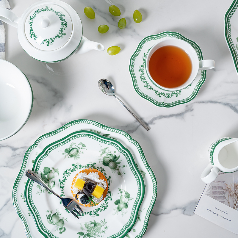 This image captures a refined tea setting featuring the green floral decal dinnerware set.