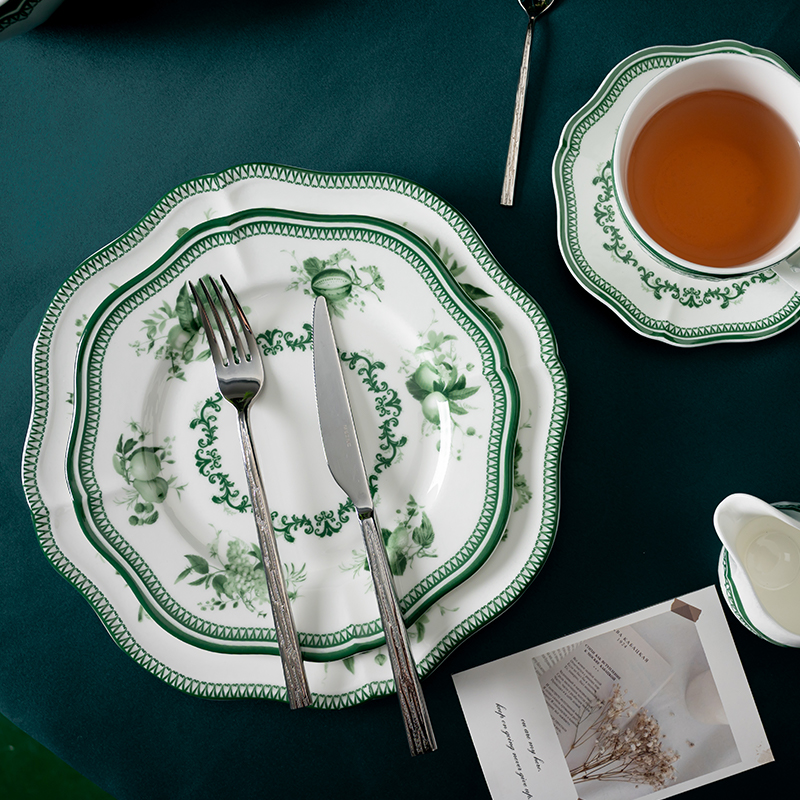 This image presents an elegant table setting featuring the green floral decal dinnerware set.