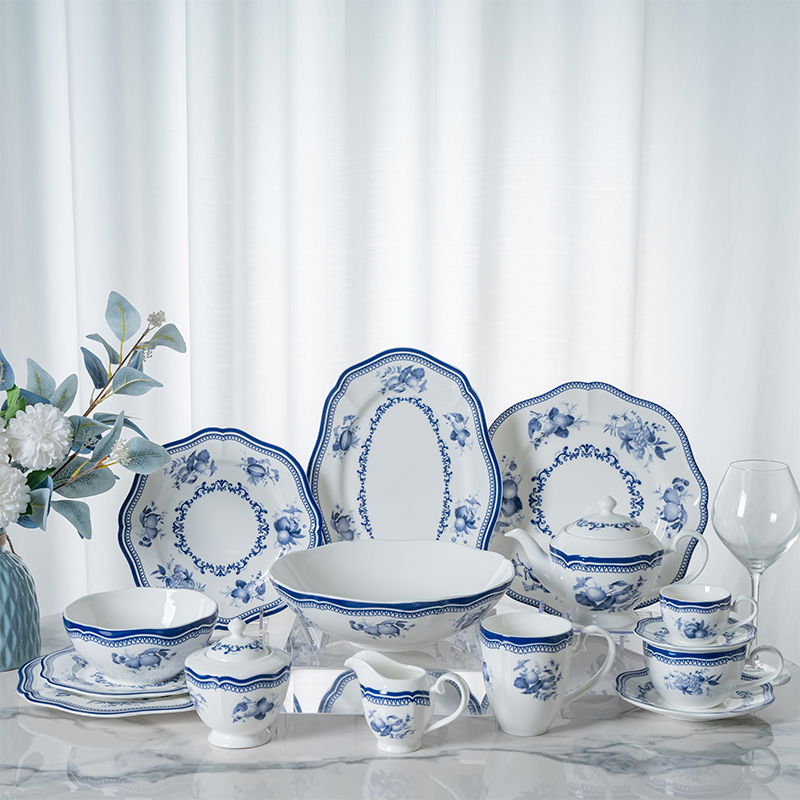 This image displays an elegant collection of blue flower porcelain dinnerware, including plates, bowls, cups, and serving dishes.