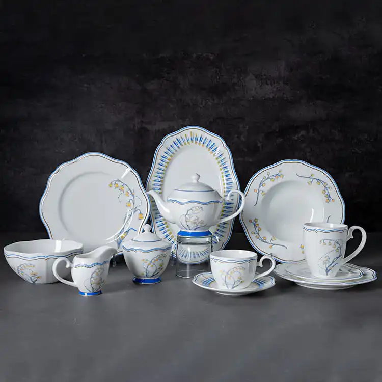 This image showcases the complete lily of the valley dinnerware collection, featuring an array of plates, cups, saucers, and a teapot, all adorned with the signature lily of the valley design.