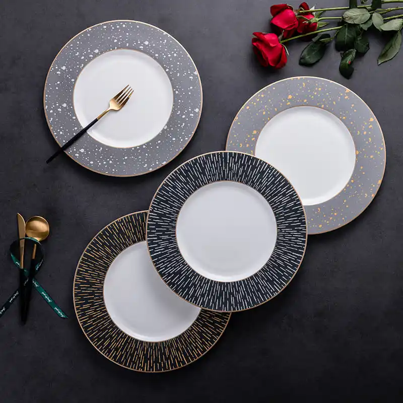 This image showcases a set of four modern dinner plates, each with a unique design on the rim.