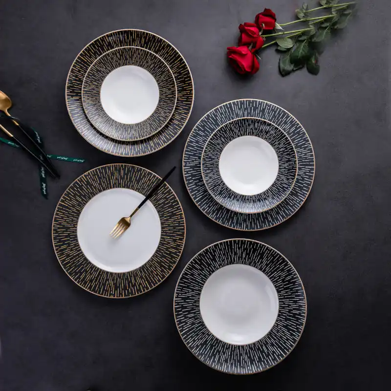 This image features a sophisticated arrangement of dinner plates, each adorned with a unique pattern of gold and white lines.