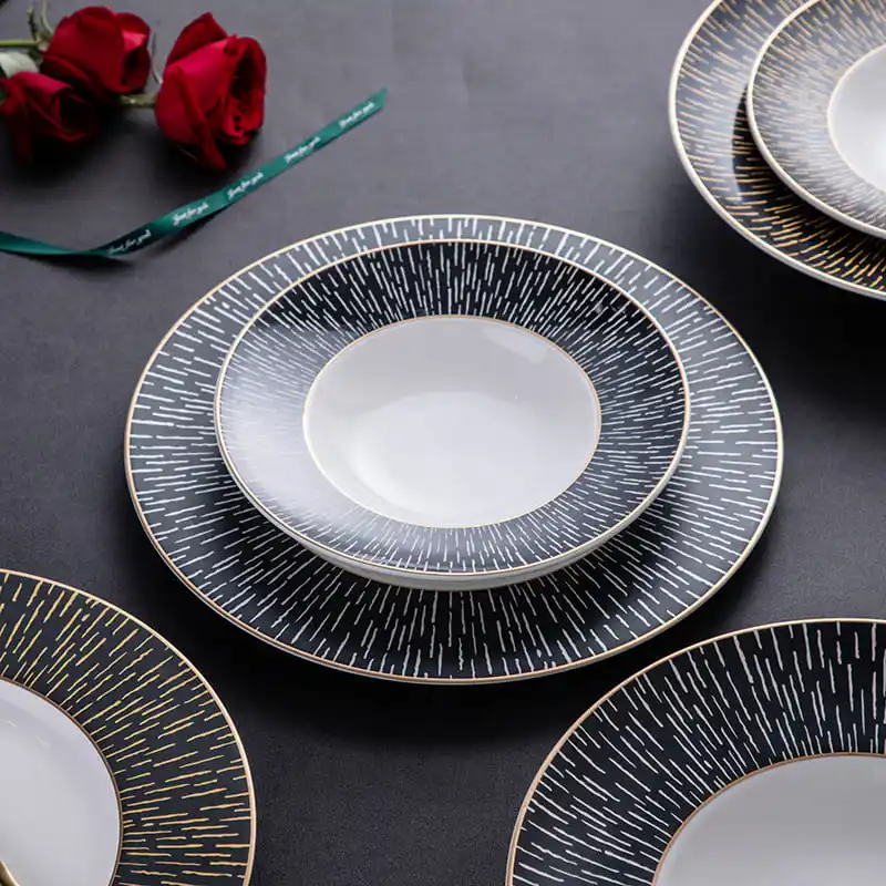 This image showcases an elegant set of bone china dinnerware, featuring plates with intricate gold and white patterns.