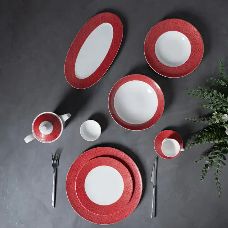 This image showcases a sophisticated dinnerware set made from high-quality bone china, featuring a striking red pattern.