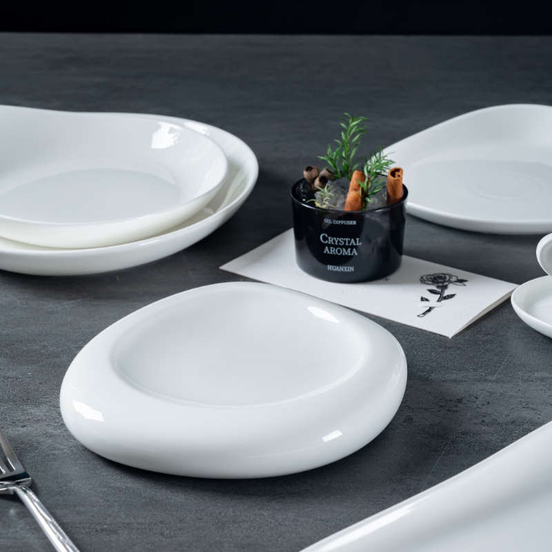 This image showcases a set of fine porcelain plates, elegantly arranged on a dark surface.