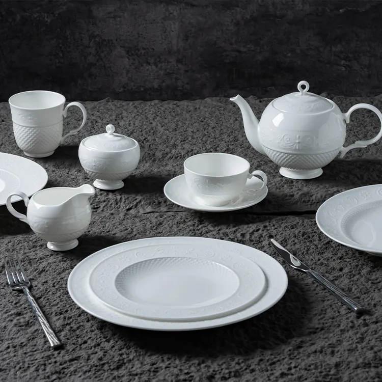 This image showcases an exquisite white bone china dinner set, meticulously arranged to highlight its elegance and sophistication.