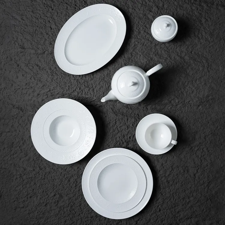 This image showcases an exquisite white bone china dinner set, featuring a variety of pieces including a teapot, plates, and a cup with a saucer.