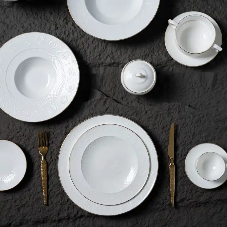 The set includes dinner plates, soup bowls, a teapot, a sugar bowl, and a teacup with a saucer, all arranged in a harmonious layout.