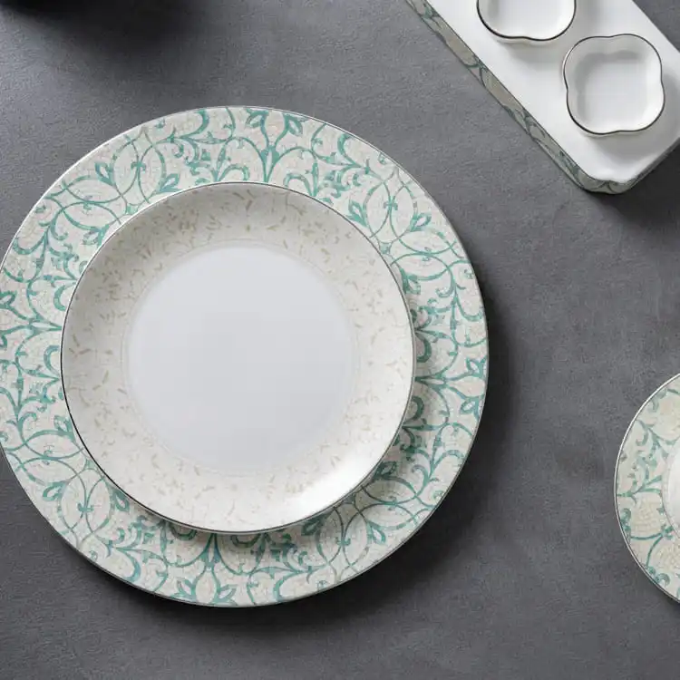 This image showcases a beautifully arranged floral dinner plate set, featuring a large dinner plate and a smaller side plate, both adorned with matching floral patterns.