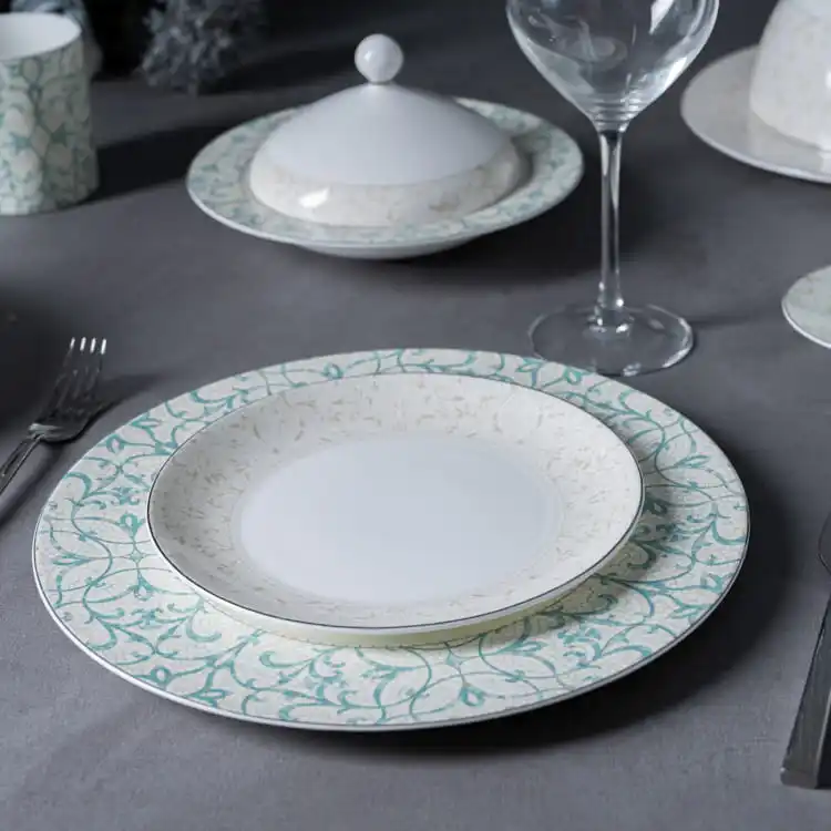 The plate and lid are crafted from high-quality bone china, known for its durability and luxurious appearance.