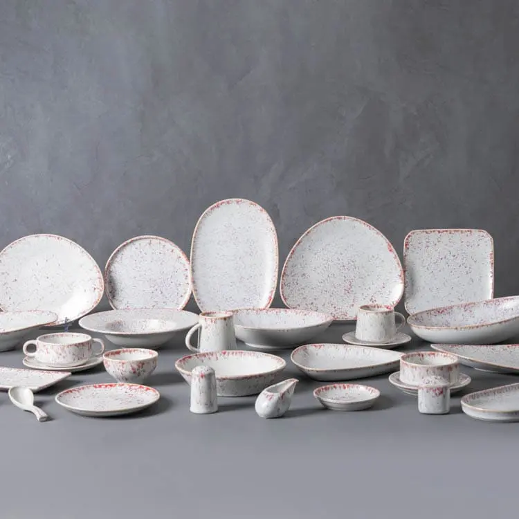 This image presents an extensive collection of pink speckled dinnerware, showcasing the full range of pieces available in this elegant line.