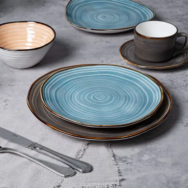 This image showcases a set of spiral pattern porcelain serving dishes, including plates, bowls, and a cup with a saucer.