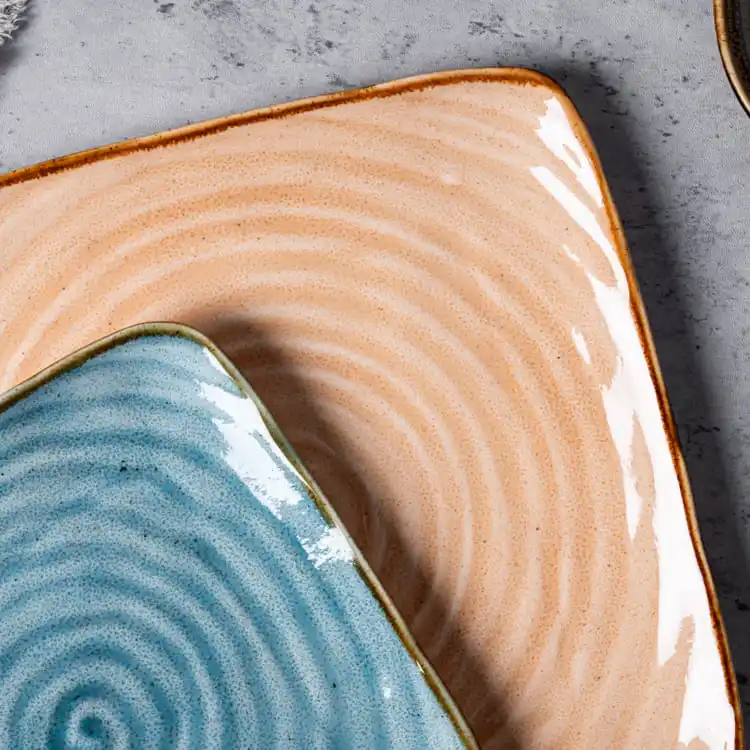 This image provides a close-up view of the spiral pattern on porcelain serving dishes, highlighting the intricate design and vibrant colors.