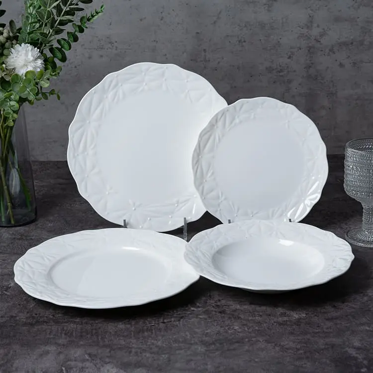 This image presents a collection of white bone china plates, each featuring a subtle, elegant pattern around the edges.