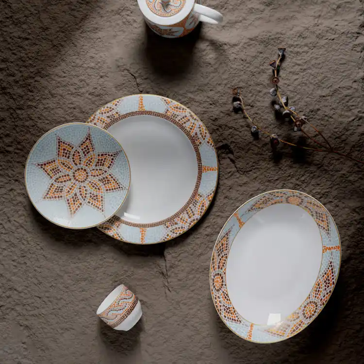 This image showcases a stunning set of decorative porcelain dinnerware, featuring intricate mosaic patterns in warm tones of orange and brown.