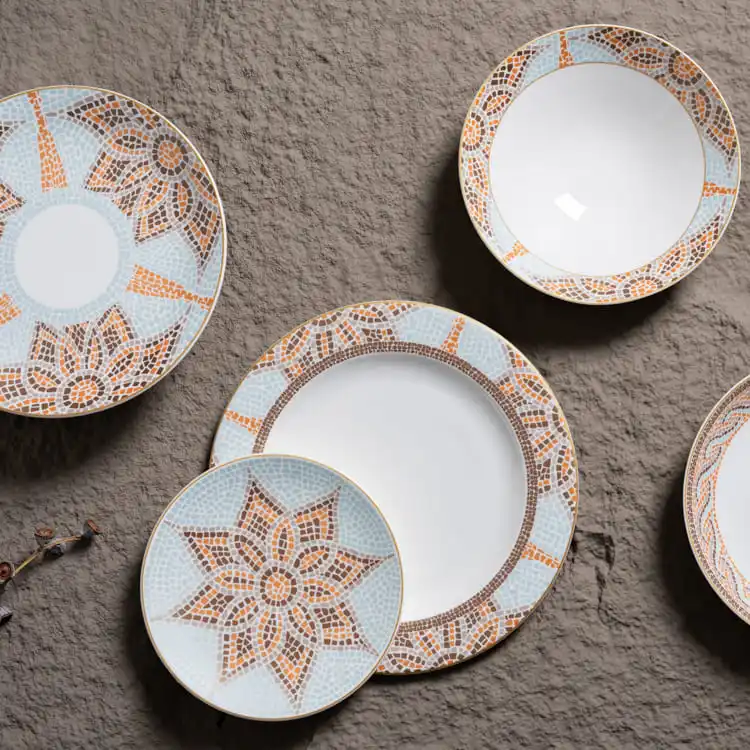 The set includes multiple plates, each with a unique design, arranged elegantly on a textured surface.