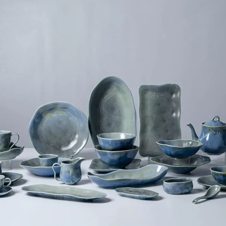 This image displays a comprehensive collection of blue-green porcelain dinnerware, including plates, bowls, cups, saucers, and serving dishes.