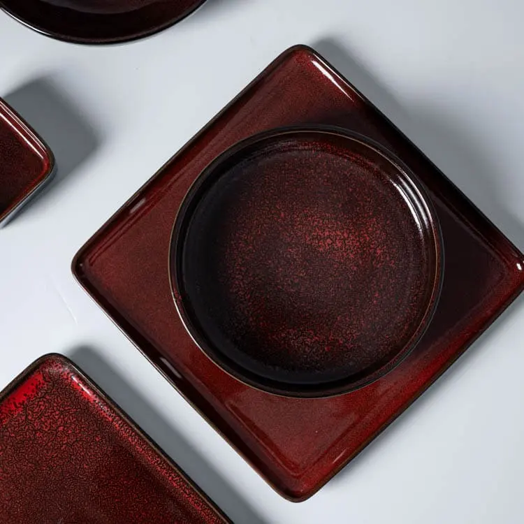 This image focuses on a square plate from the crimson red porcelain dish set, showcasing its unique design and rich color.