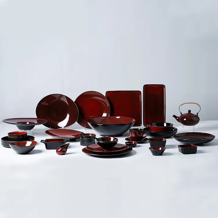 This image presents the full range of the crimson red porcelain dish set, featuring an extensive array of pieces including plates, bowls, teapots, and serving dishes.