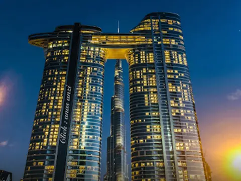 Exterior night view of Address Sky View Dubai twin towers connected by the Sky Bridge.