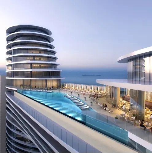 Rooftop infinity pool and outdoor dining area at Address Sky View with ocean views.