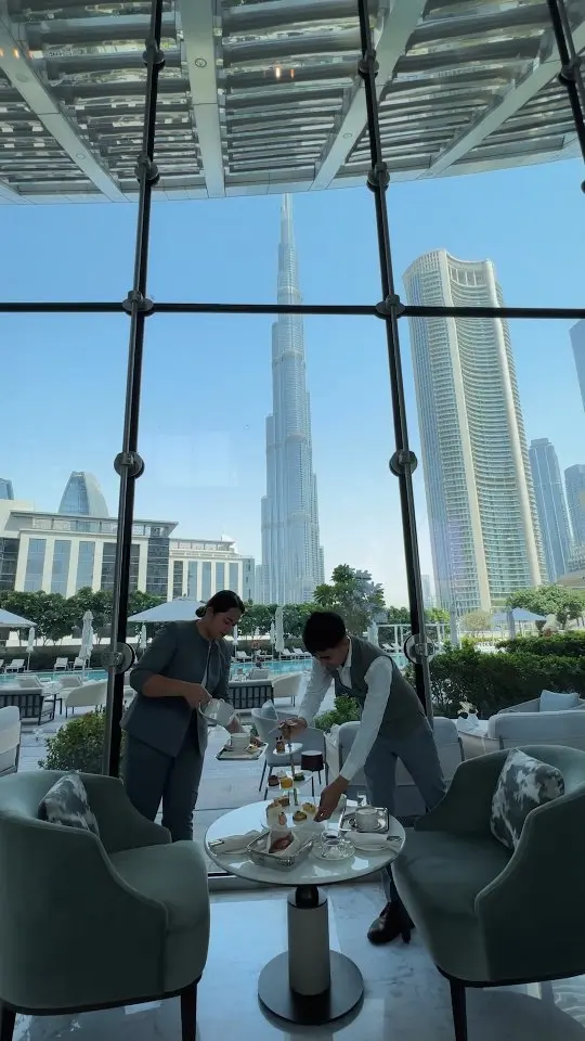 Staff serving afternoon tea with PITO bone china tableware in the Lobby Lounge overlooking Burj Khalifa.