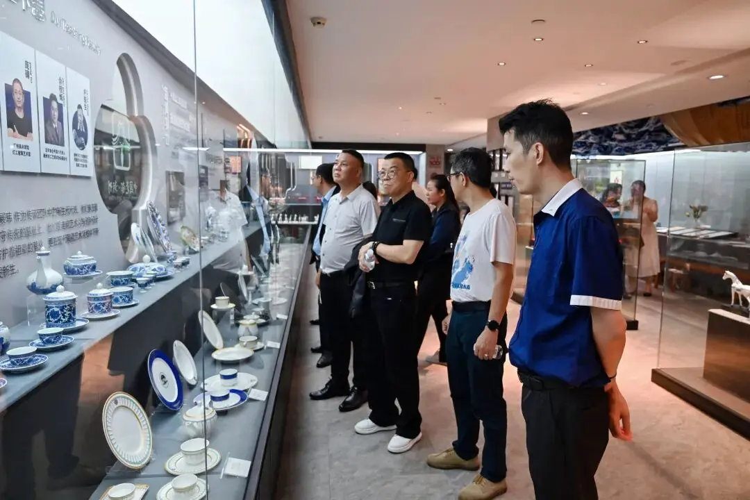 Guests inspect blue-and-white porcelain tableware displays in the PITO museum.