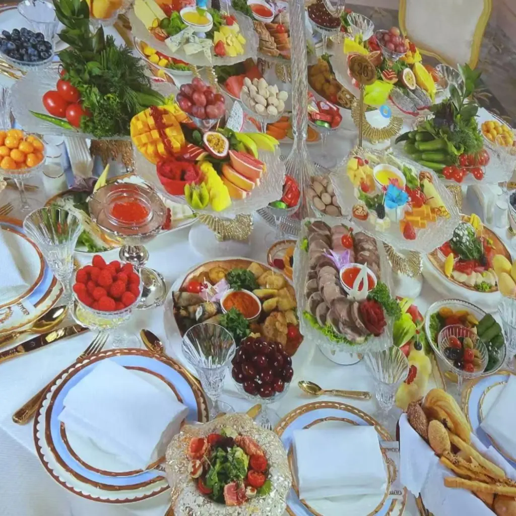 Banquet table at Versal, Uzbekistan, set with custom fine china featuring gold and blue rims for a premium dining experience.