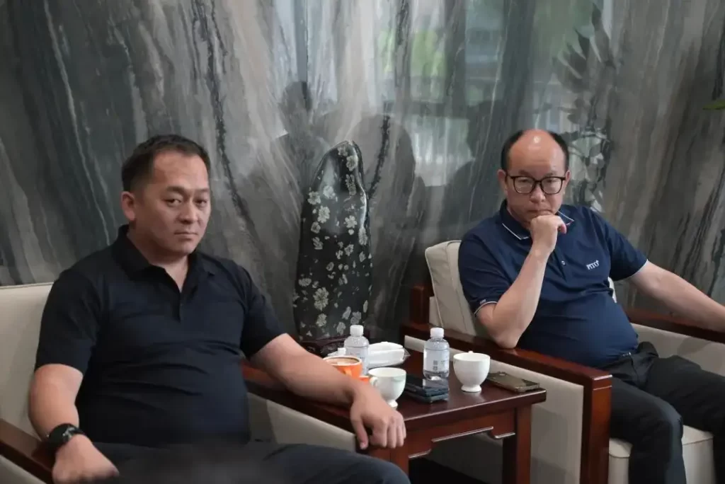 Kyrgyz and PITO officials discuss cooperation while seated in an office, with a rock sculpture in the background.