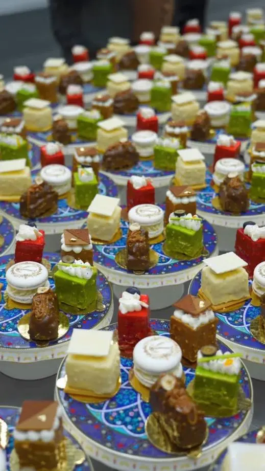 Assorted pastries on custom high-temp porcelain plates with blue patterns at Versal breakfast buffet